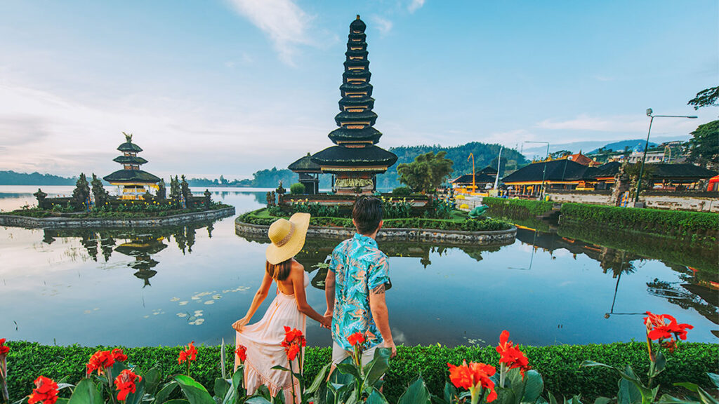 Couple spending time at the ulun datu bratan temple in Bali. Concept about exotic lifestyle wanderlust traveling